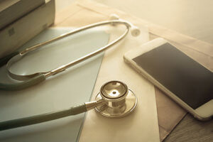 stethoscope and phone illustrating elective medical practice mobile solutions
